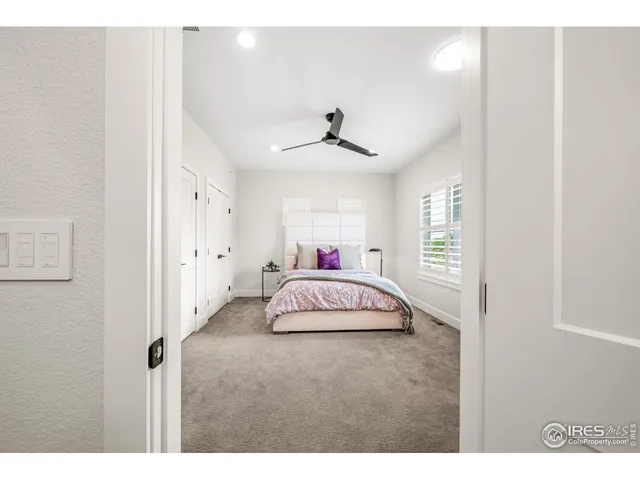 a spacious bedroom with a bed and a window