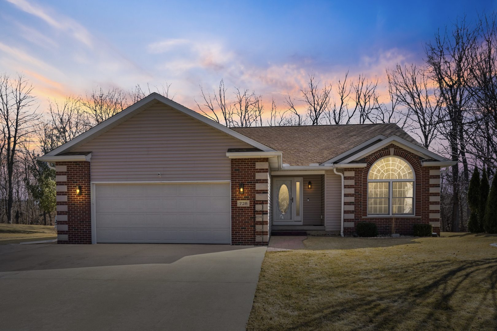 728 10th Ave Court Hampton, IL 61256 - Photo 1 of 35 a front view of a house with a garden and trees