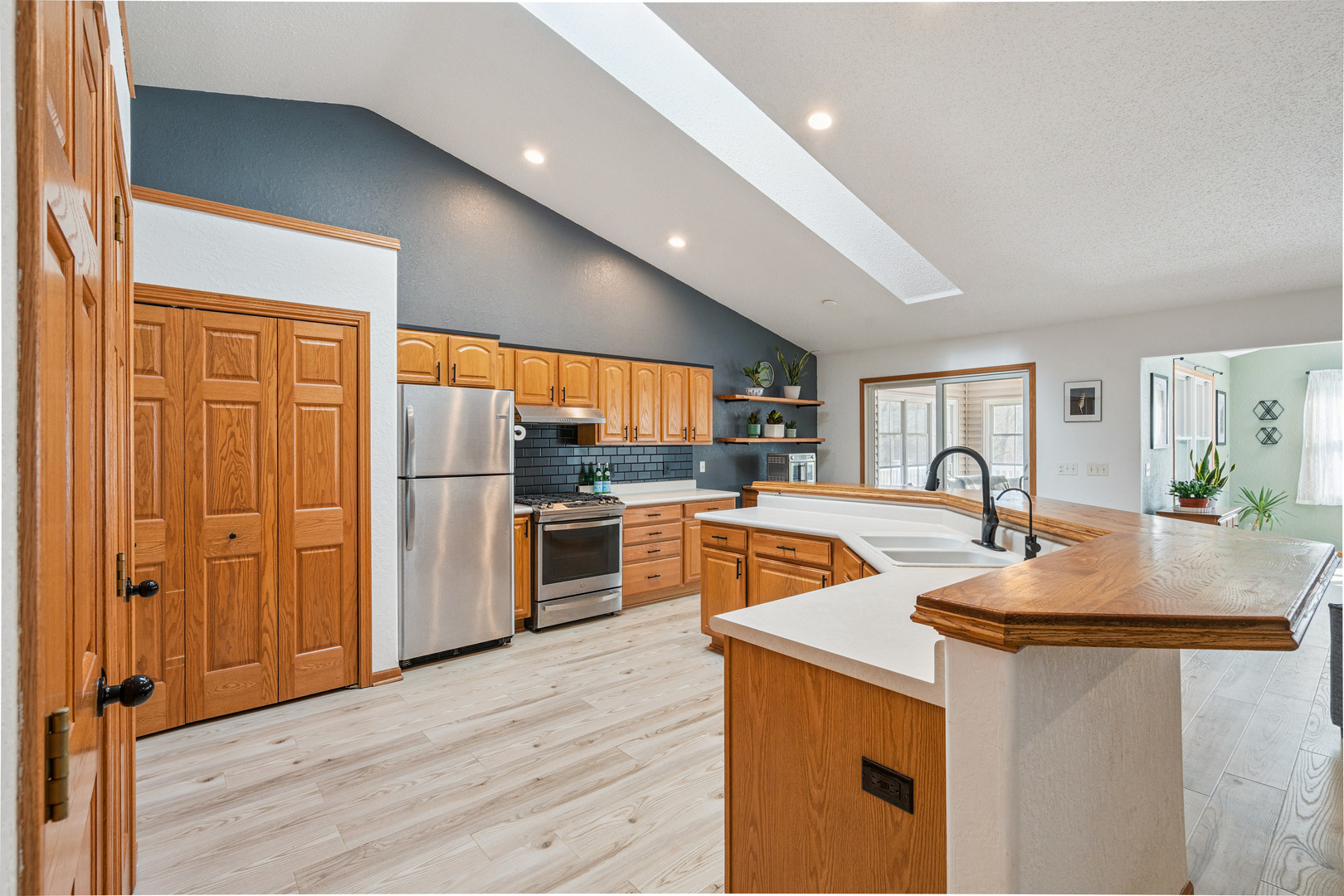 728 10th Ave Court Hampton, IL 61256 - Photo 8 of 35 a kitchen with stainless steel appliances granite countertop a refrigerator a sink dishwasher and white cabinets with wooden floor