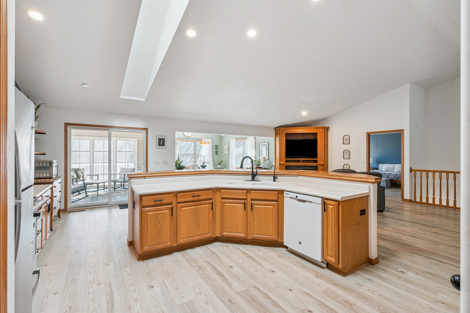 728 10th Ave Court Hampton, IL 61256 - Photo 9 of 35 a large kitchen with stainless steel appliances kitchen island granite countertop wooden floors and white cabinets