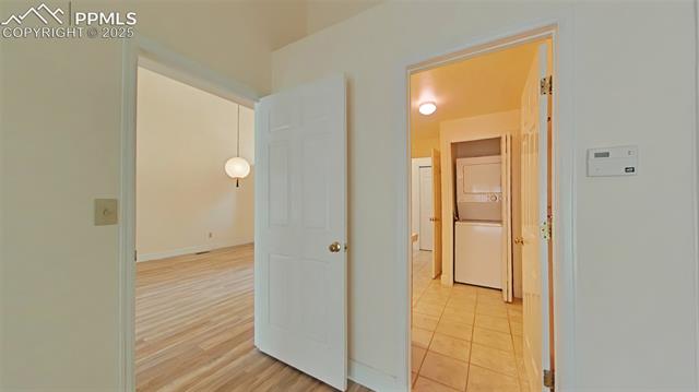 460 Autumn Ridge Circle, Unit D Colorado Springs, CO 80906 - Photo 28 of 38 Hall featuring stacked washer and dryer and baseboards