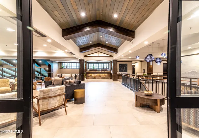 a lobby with furniture and a chandelier