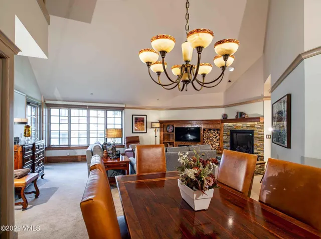 a living room with fireplace furniture and a large window