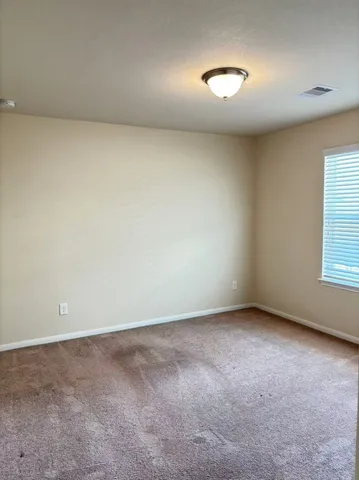 an empty room with a empty space and windows