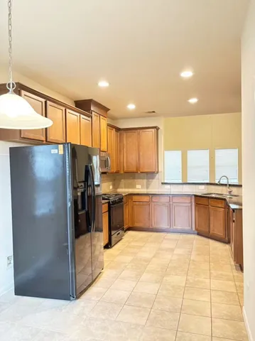 a large kitchen with a large counter top and outdoor space