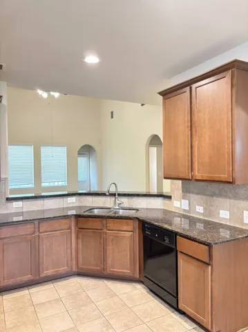 a kitchen with a sink stove top oven and cabinets
