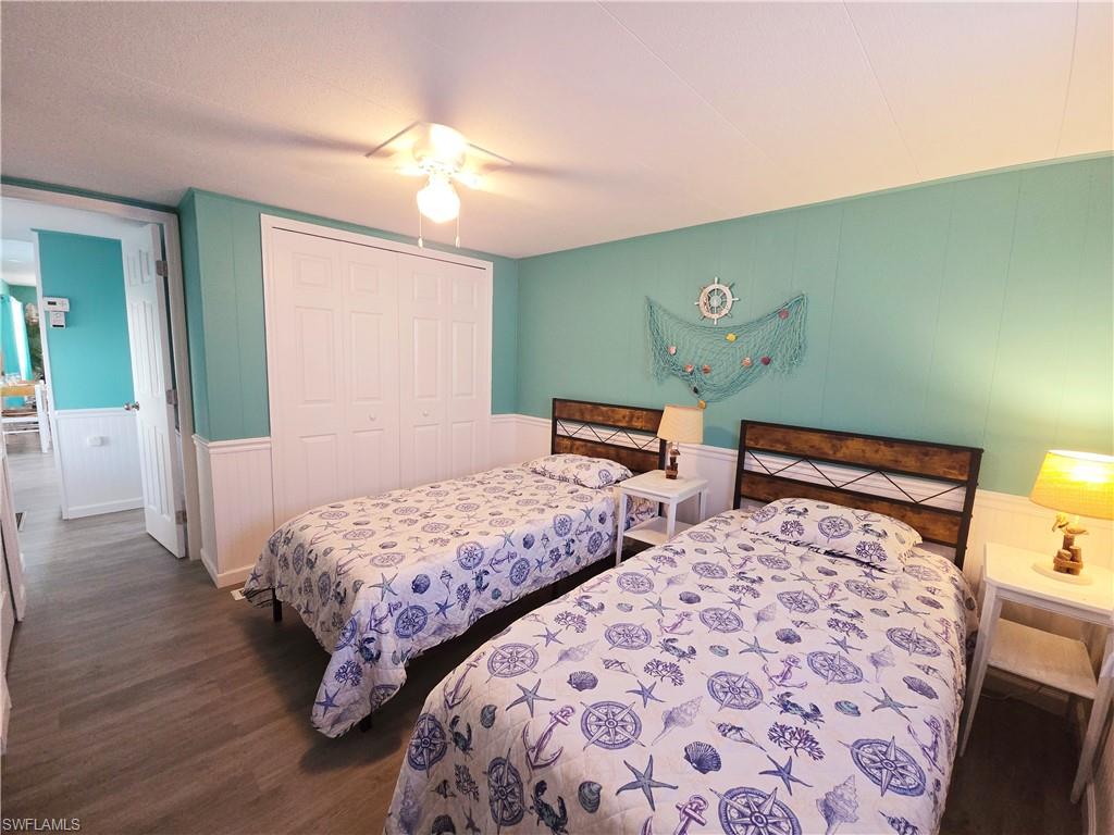 19 Moorhead Manor Naples, FL 34112 - Photo 14 of 33 a bedroom with two beds and a mirror