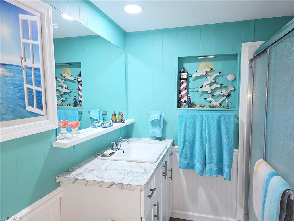 19 Moorhead Manor Naples, FL 34112 - Photo 16 of 33 a bathroom with a sink and a mirror