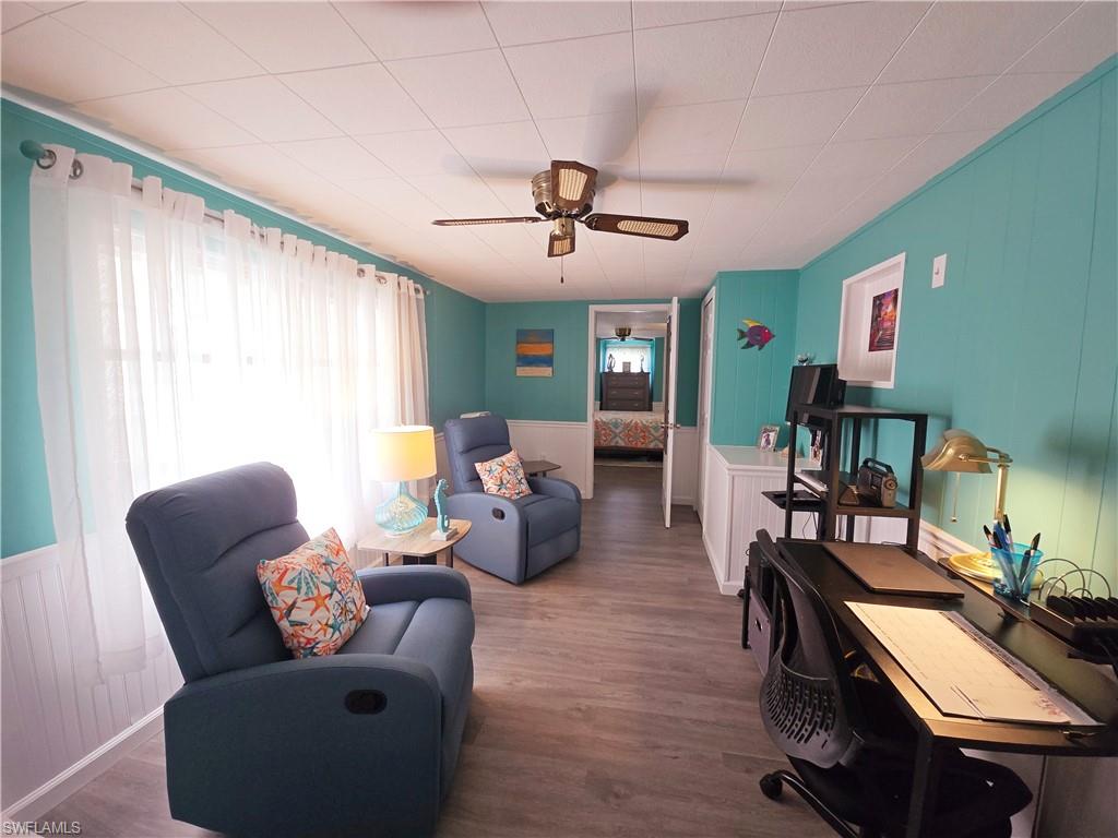 19 Moorhead Manor Naples, FL 34112 - Photo 20 of 33 a living room with furniture and a wooden floor