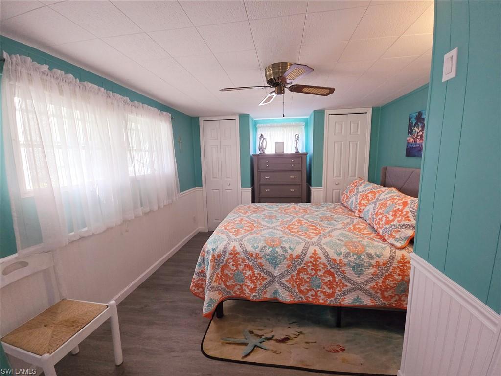 19 Moorhead Manor Naples, FL 34112 - Photo 21 of 33 a bedroom with a bed and a mirror