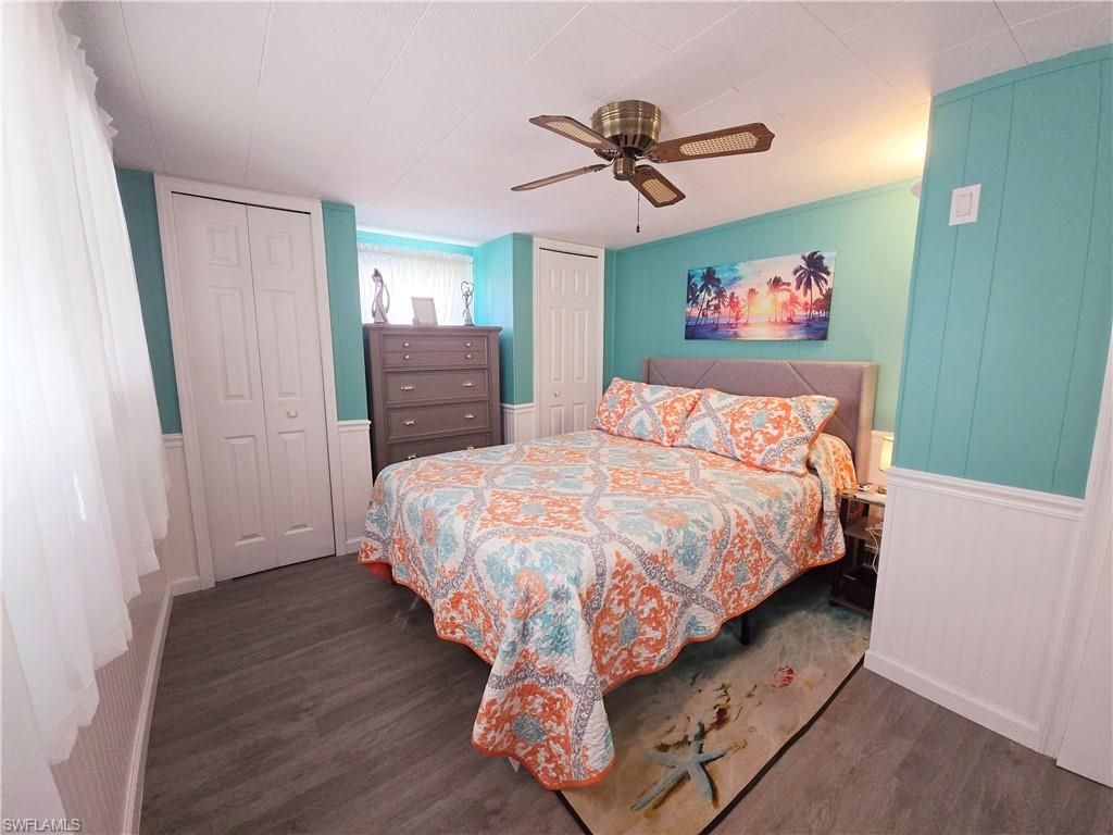 19 Moorhead Manor Naples, FL 34112 - Photo 23 of 33 a bed sitting in a bedroom and a chandelier