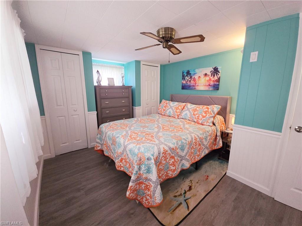 19 Moorhead Manor Naples, FL 34112 - Photo 24 of 33 a bedroom with a bed and a chandelier
