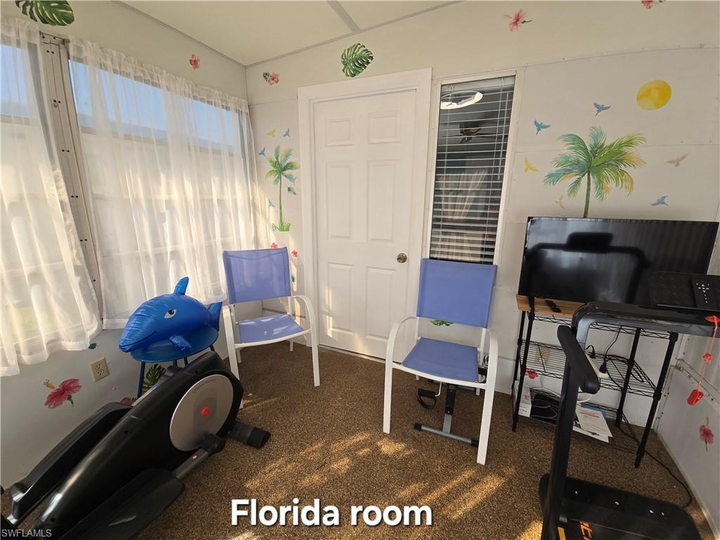 19 Moorhead Manor Naples, FL 34112 - Photo 25 of 33 a living room with furniture and a window