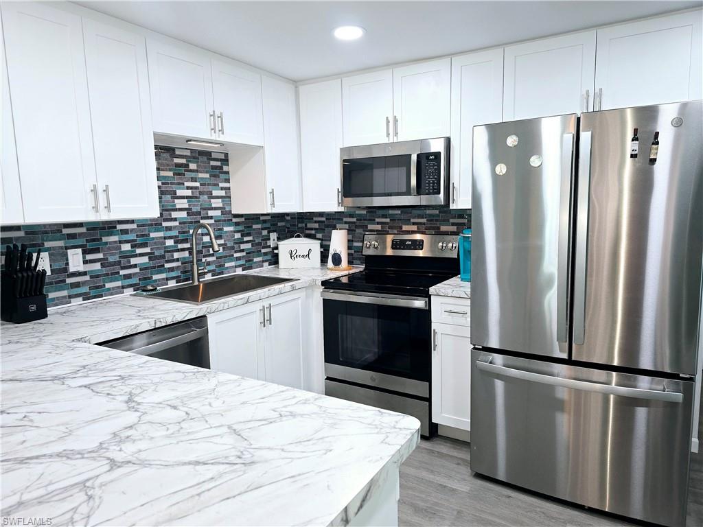 19 Moorhead Manor Naples, FL 34112 - Photo 6 of 33 a kitchen with a refrigerator stove and microwave