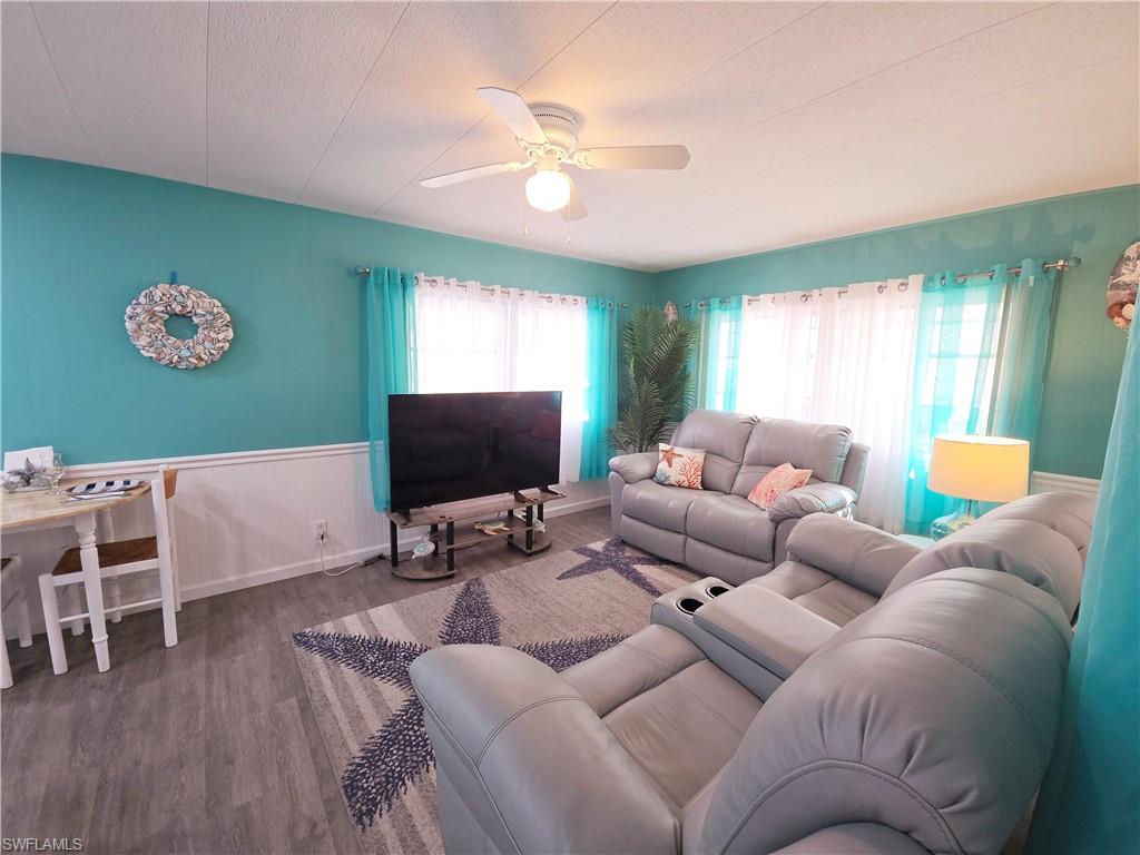 19 Moorhead Manor Naples, FL 34112 - Photo 10 of 33 a living room with furniture and a flat screen tv