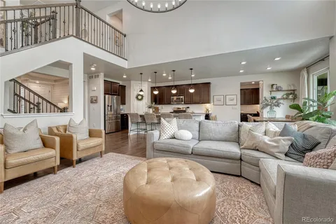 a living room with furniture and a view of kitchen