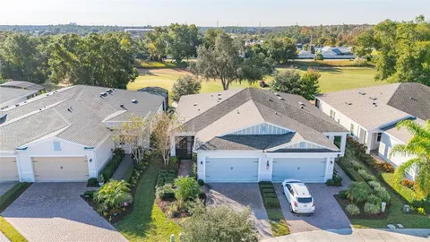 an aerial view of a house with a garden and lake view