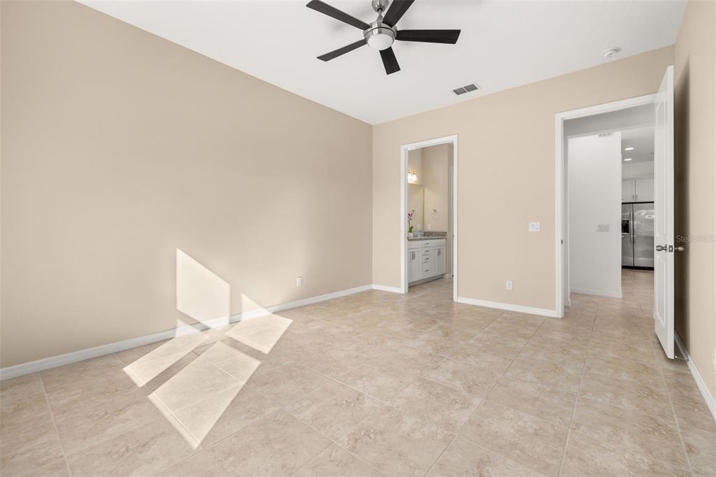 1855 Flora Pass Place Kissimmee, FL 34747 - Photo 18 of 41 a view of a livingroom with a ceiling fan and window