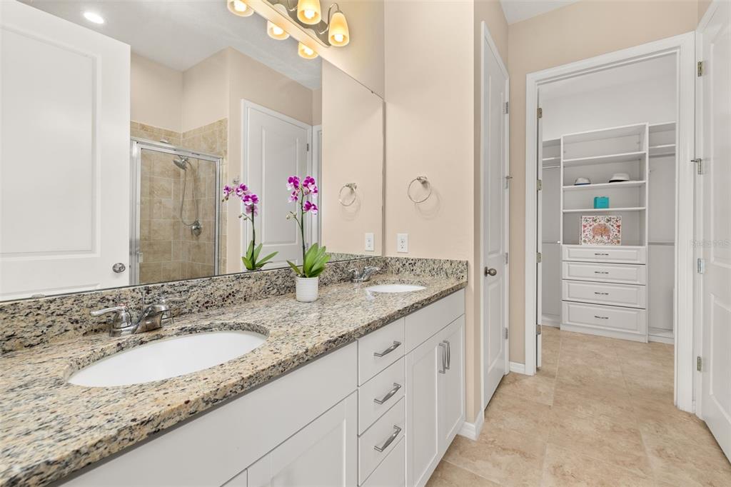 1855 Flora Pass Place Kissimmee, FL 34747 - Photo 21 of 41 a bathroom with a granite countertop double vanity sink mirror and