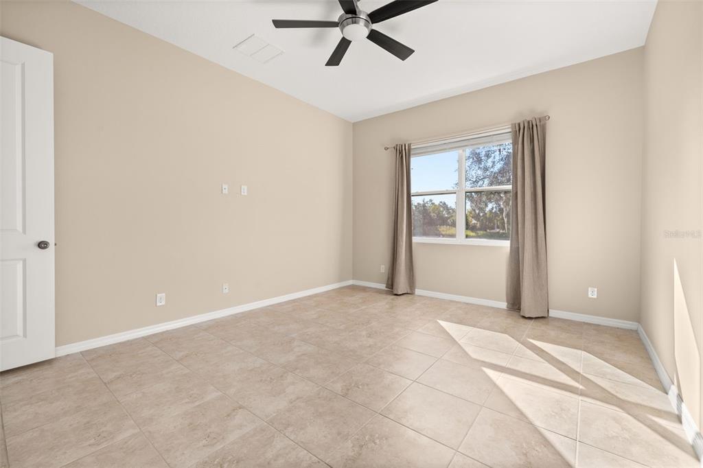 1855 Flora Pass Place Kissimmee, FL 34747 - Photo 23 of 41 a view of a livingroom with a ceiling fan and window
