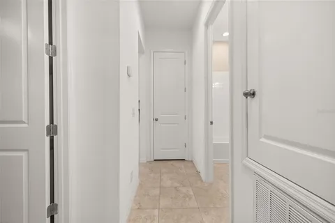 a living room with furniture floor to ceiling window and potted plants