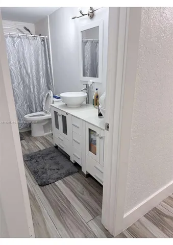 a bathroom with a sink a mirror and a toilet