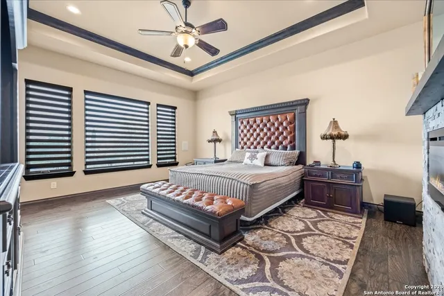 a spacious bedroom with a bed and a chandelier