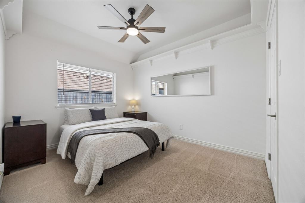 9217 Inverness Drive Rowlett, TX 75089 - Photo 23 of 40 Comfortable Secondary Bedroom — This bedroom offers a bright, flexible layout with updated ceiling fan lighting and room to serve as a guest space, hobby room, or additional retreat.