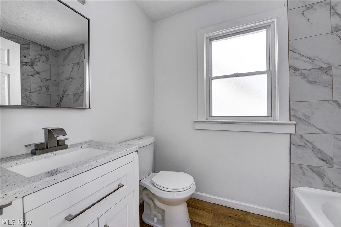 3164 Whitethorn Road Cleveland, OH 44118 - Photo 16 of 31 Full bathroom with vanity, toilet, hardwood / wood-style flooring, and tiled shower / bath