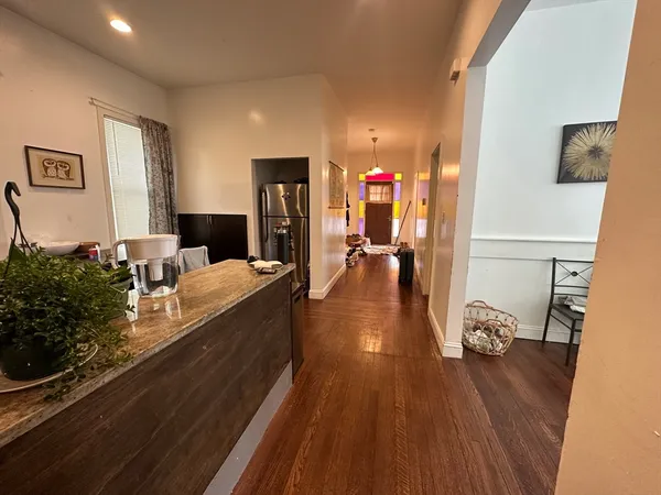 a living room with furniture and wooden floor