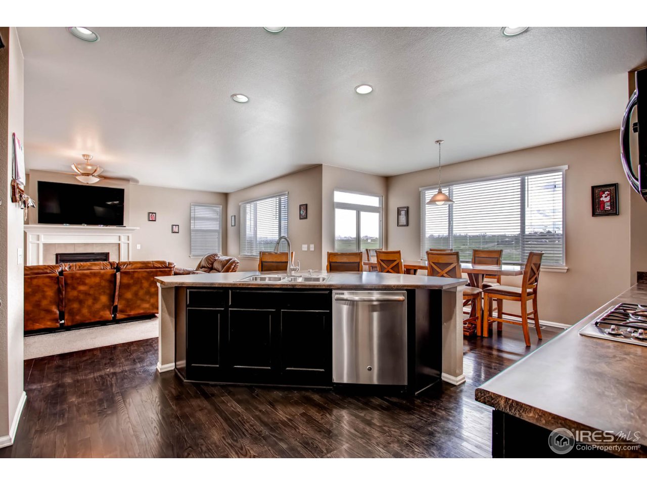 8615 Raspberry Drive Frederick, CO 80504 - Photo 13 of 28 a view of kitchen with stainless steel appliances granite countertop a stove and a living room