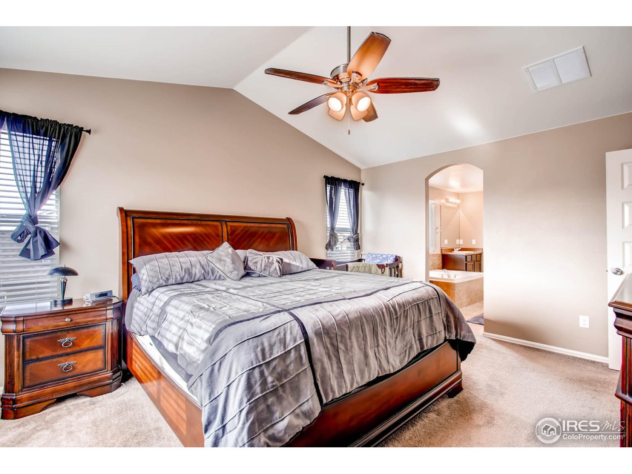 8615 Raspberry Drive Frederick, CO 80504 - Photo 18 of 28 a bedroom with a bed and a chandelier