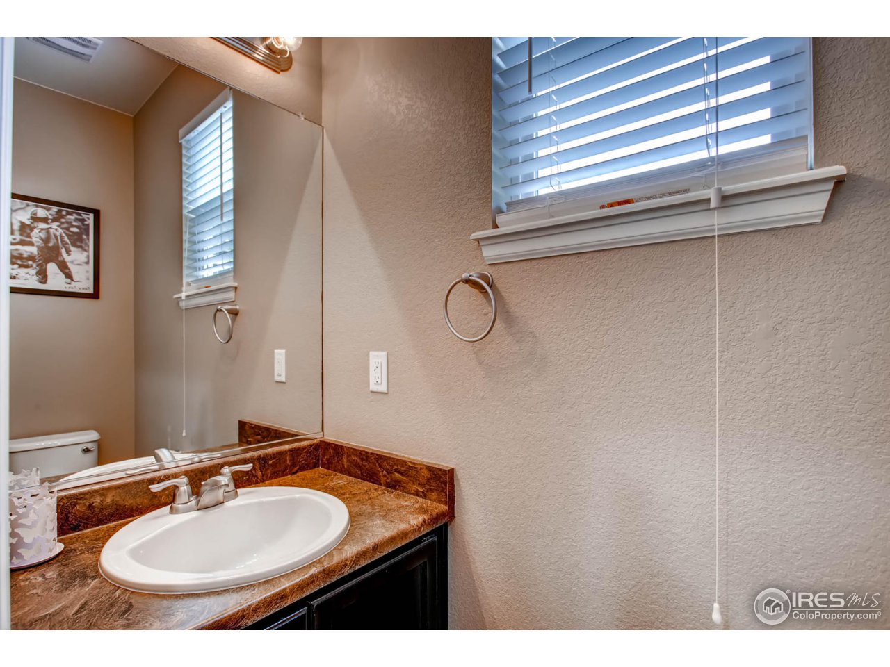 8615 Raspberry Drive Frederick, CO 80504 - Photo 25 of 28 a bathroom with a sink and a mirror