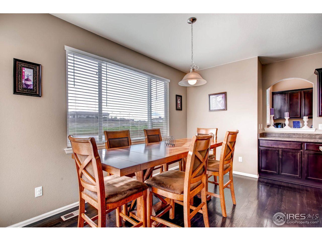 8615 Raspberry Drive Frederick, CO 80504 - Photo 8 of 28 a view of a dining room with furniture and wooden floor
