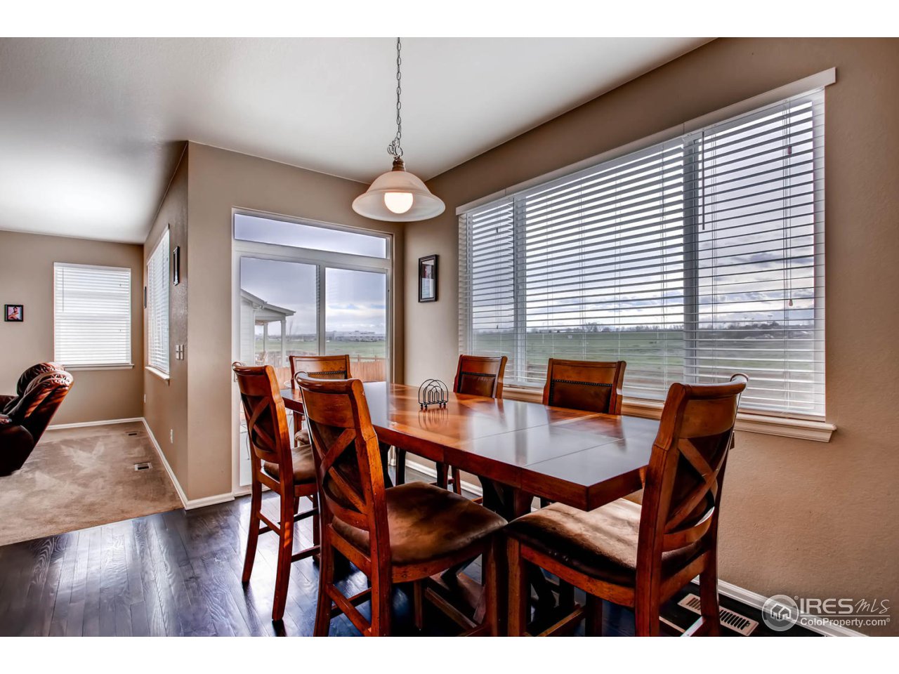 8615 Raspberry Drive Frederick, CO 80504 - Photo 9 of 28 a view of a dining room with furniture window and wooden floor