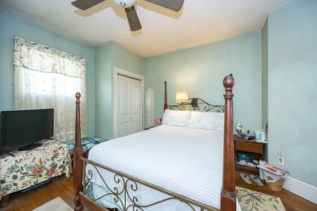 a bedroom with a bed and a flat screen tv