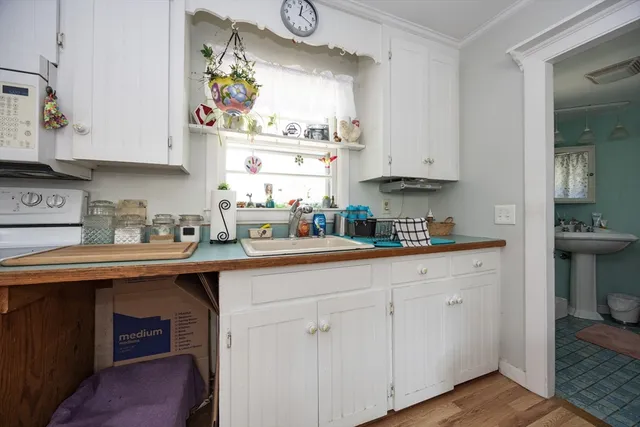 a kitchen with stainless steel appliances white cabinets and a sink