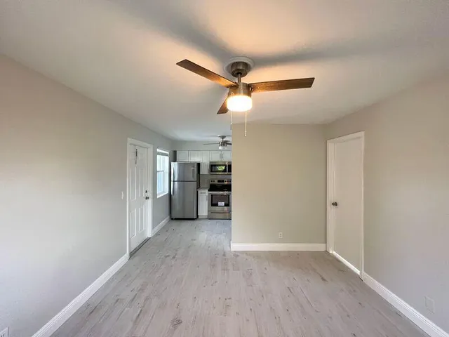 a view of a kitchen with a sink and a refrigerator