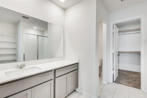a bathroom with a glass shower door