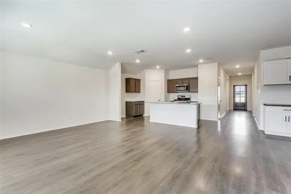 a view of kitchen with microwave and refrigerator