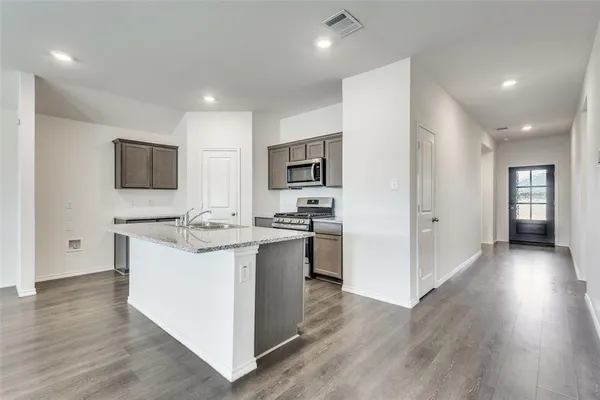 a kitchen with a sink and steel appliances