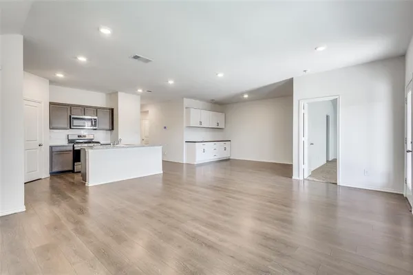 a view of kitchen with wooden floor and electronic appliances