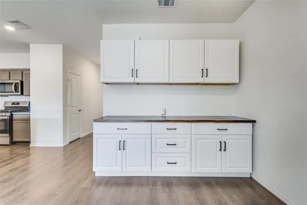 a kitchen with white cabinets