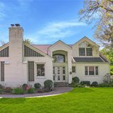 a front view of a house with a garden and plants