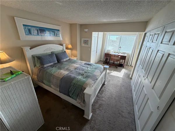 a bedroom with a bed couch and a window