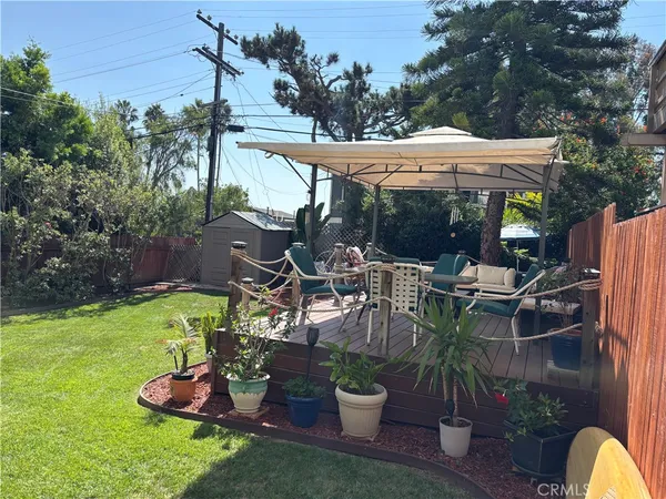 a view of a chair and table in backyard of the house