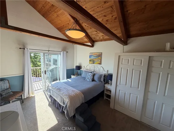 a bedroom with a bed and large window