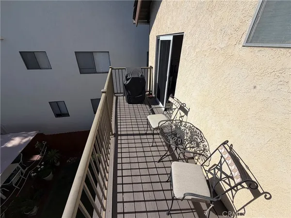 a view of a balcony with chairs