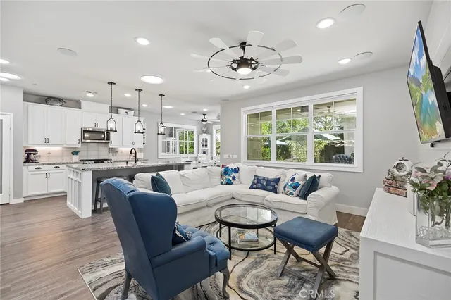 a living room with furniture a flat screen tv and a fireplace