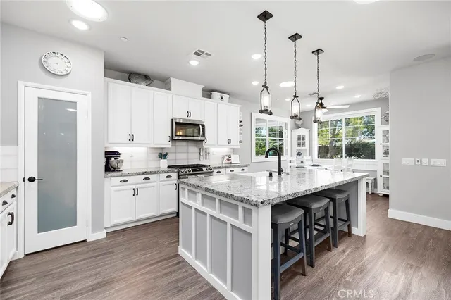 a open kitchen with stainless steel appliances granite countertop a stove and cabinets